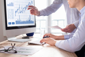 Team of Traders Working with Foreign Exchange Trading Charts and graphs on computer screen