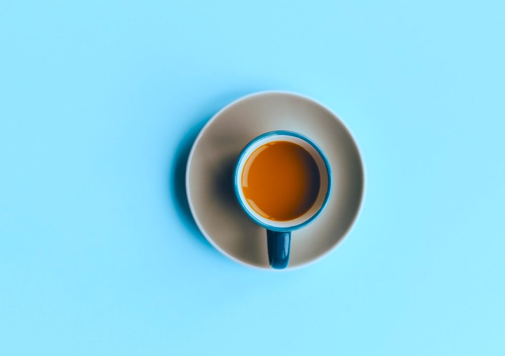 A Cup Of Coffee On A Blue Background + Make Choices that Increase Your Wealth
