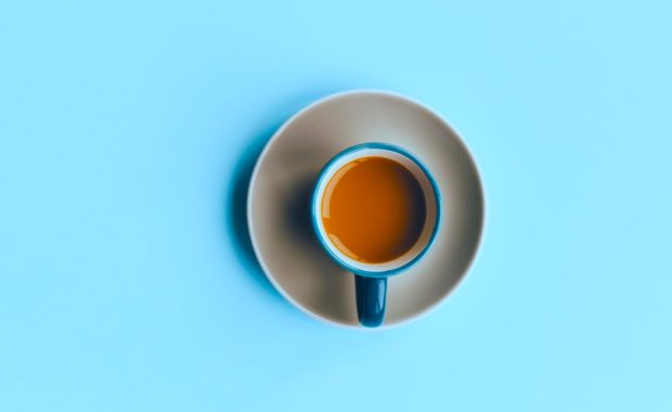 A Cup Of Coffee On A Blue Background + Make Choices that Increase Your Wealth