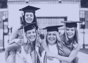 Four Girls Smiling While Wearing A Graduation Cap