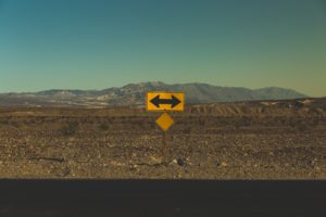 A Road With A Sign Pointing In Opposite Directions + Dealing with Financial Insecurity