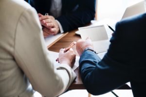 A Fiduciary Advisor Sitting With A Couple Discussing A Financial Plan