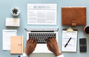 Financial Advisor on Laptop with Paperwork