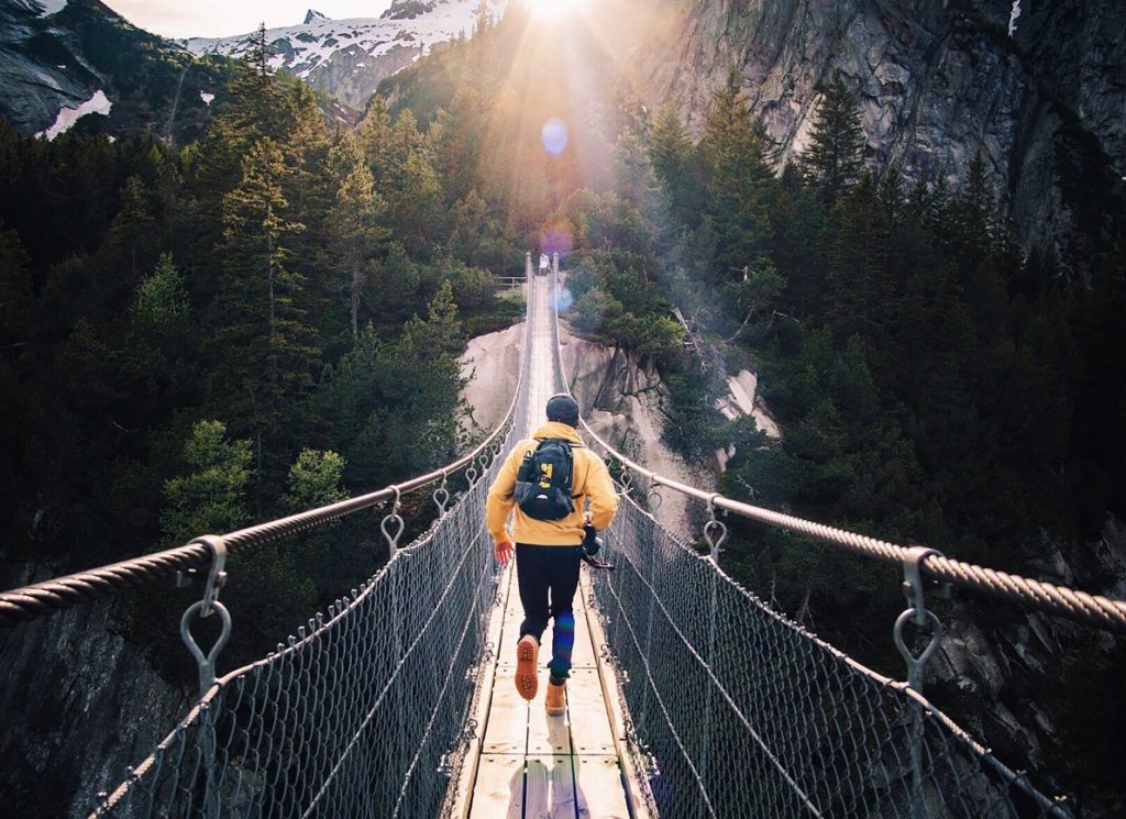 A Person Walking Across a Bridge and Benefits of Spending Time Outdoors