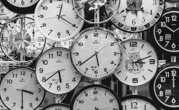 Black and White Photo of Clocks