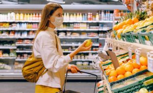 Women in Mask Shopping at a Grocery Store During Pandemic