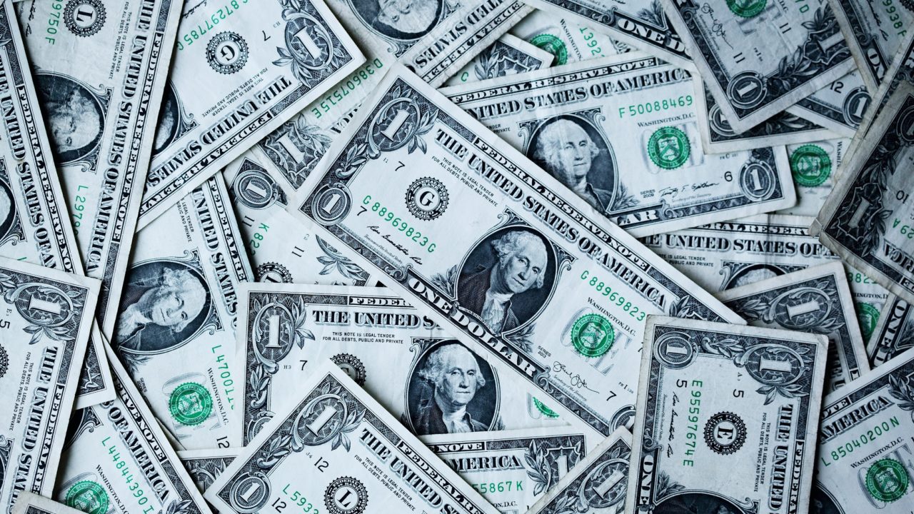 A Large Pile Of One Dollar Bills - Creating a Retirement Paycheck