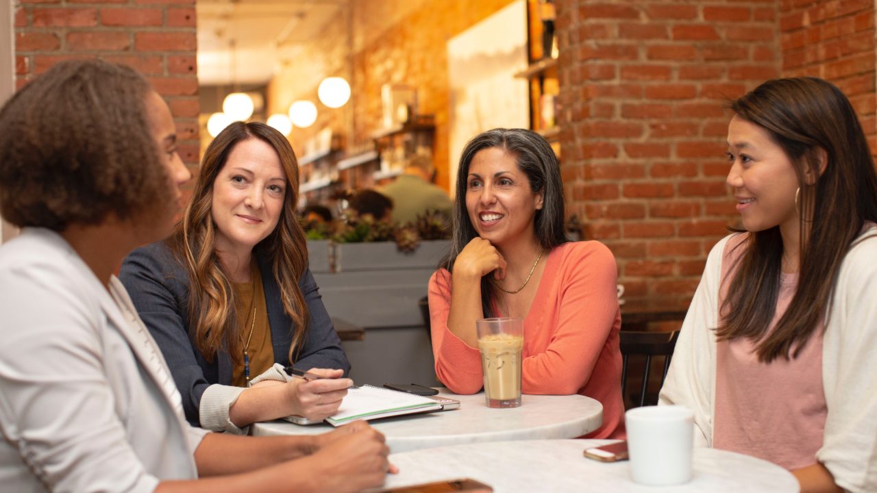 A Women's Conversation Circle Discussing Retirement At A Coffee Shop