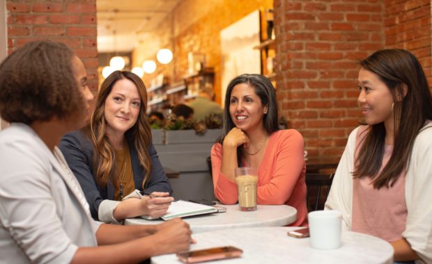 A Group Of Women Discussing Retirement At A Coffee Shop