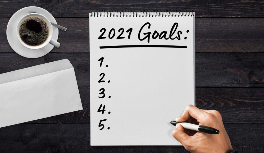 A Notebook With 2021 Goals For Financial New Year's Resolution and Five Favorite Reads for the Week of January 2