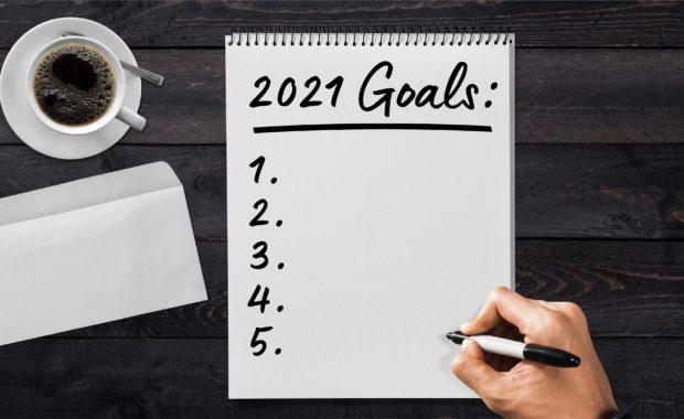 A Notebook With 2021 Goals For Financial New Year's Resolution