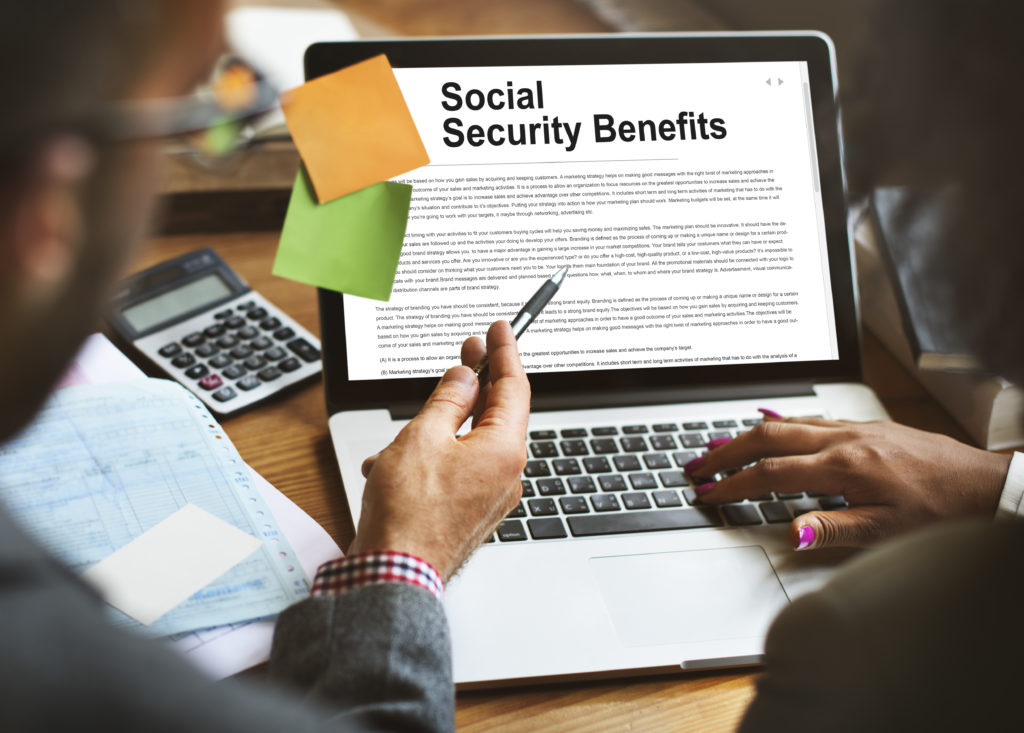 Financial Advisors On A Laptop Reviewing Social Security Benefits Agreement