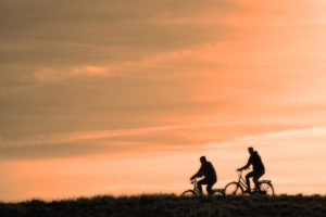 Two People Cycling During Sunset and How to Keep Your Brain Health and Happy