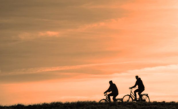 Two People Cycling During Sunset and How to Keep Your Brain Health and Happy